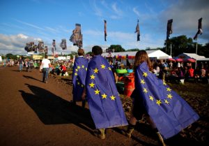Revellers wrapped in European Union flags walk at Worthy Farm in Somerset during the Glastonbury Festival, Britain, June 22, 2016. REUTERS/Stoyan Nenov - RTX2HNDJ